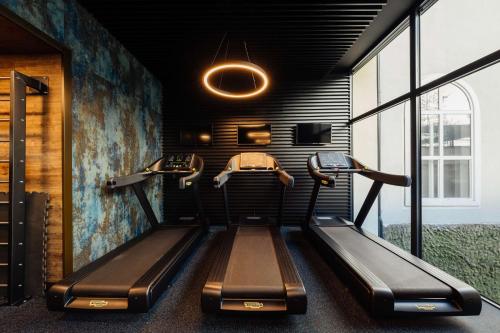 a gym with two treadmills in a room at Radisson Blu Carlton Hotel, Bratislava in Bratislava