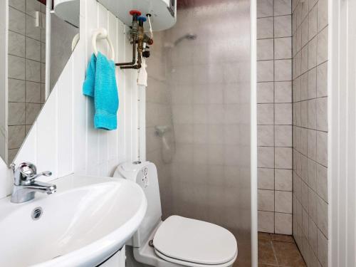 a bathroom with a white toilet and a sink at Two-Bedroom Holiday home in Hurup Thy 2 in Sindrup