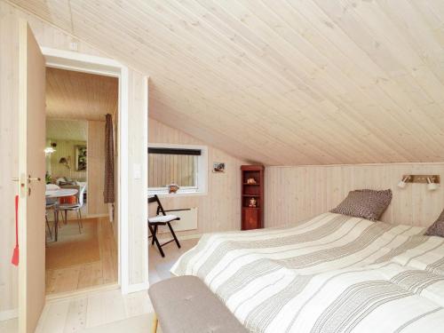 a bedroom with a large bed in a room at Holiday home Frederiksværk XXIV in Frederiksværk