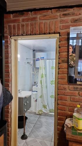 a bathroom with a shower curtain and a sink at Loft casa dos pisos con garage pocitos playa 4 personas in Montevideo