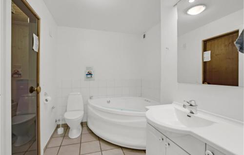a white bathroom with a tub and a toilet and a sink at 3 Bedroom Beautiful Home In Aabenraa in Aabenraa