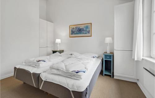 a bedroom with a bed with white sheets and pillows at 3 Bedroom Beautiful Home In Aabenraa in Aabenraa