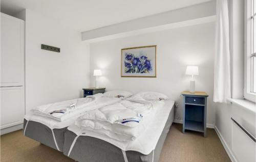 a white bedroom with a bed and two night stands at 3 Bedroom Beautiful Home In Aabenraa in Aabenraa