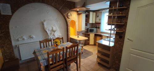 a kitchen and dining room with a table and chairs at Agroturystyka Przylesie in Hajnówka