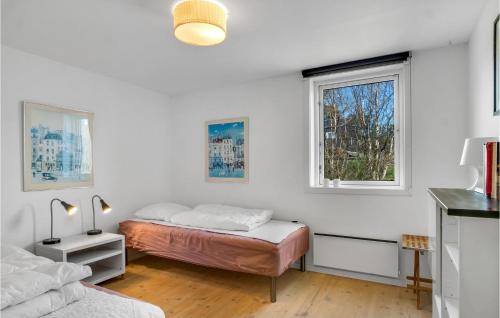 エーベルトフトにあるGorgeous Home In Ebeltoft With House Sea Viewの白い部屋 ベッド2台 窓2つ付