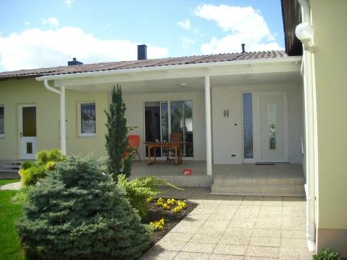 a small white house with a patio at Gästehaus Josef Lang in Andau