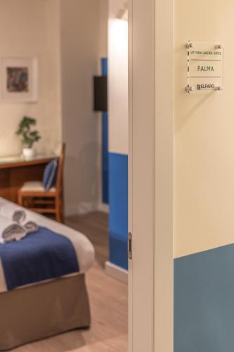 a room with a bed and a table with a sign at Vittoria Garden Suites in Rome