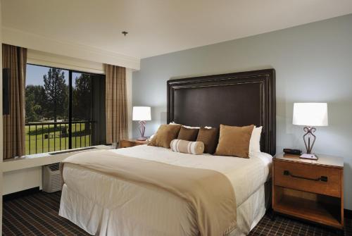 a bedroom with a large bed and a large window at The Lodge at Eagle Crest in Redmond