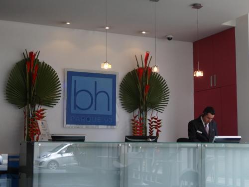 a man sitting at a counter in an office at Hotel bh Parque 93 in Bogotá
