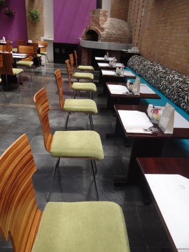 a row of tables and chairs in a restaurant at Hotel bh Parque 93 in Bogotá