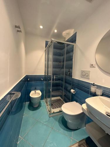 a bathroom with a shower and a toilet and a sink at De Riso Apartments Luxury Amalfi Coast in Minori
