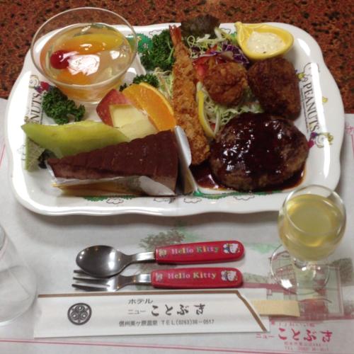 a plate of food with food on a table at Hotel New Kotobuki in Matsumoto