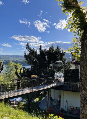 a bridge in front of a house with a view at Terrazza sul lago in Ameno