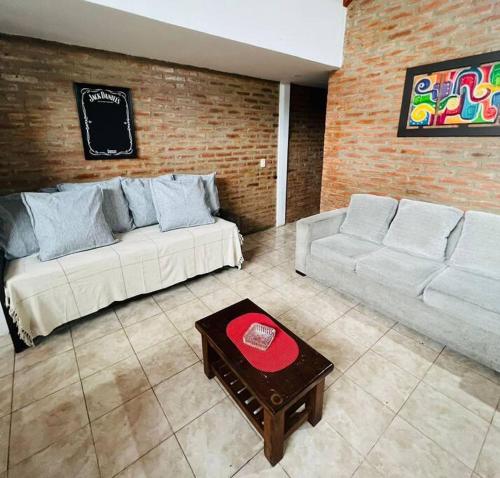 a living room with two couches and a coffee table at Departamento Centrico in Villa General Belgrano