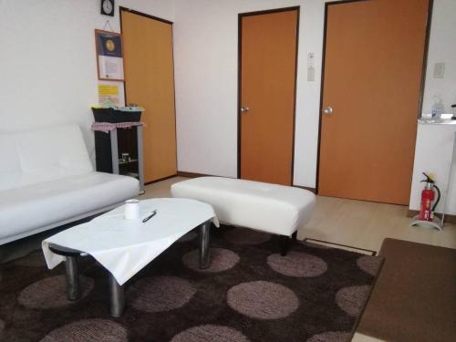 a living room with a couch and a coffee table at Corpo Marika 0 in Hakodate