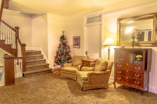 a living room with a christmas tree in the corner at Hassayampa Inn in Prescott