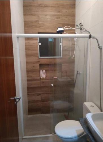 a bathroom with a shower with a toilet and a sink at Casa para locação in Atibaia