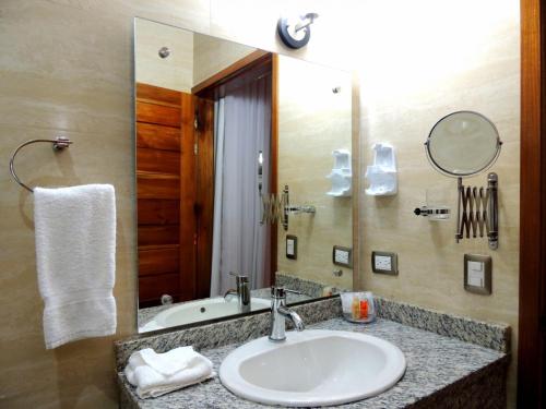 a bathroom with a sink and a mirror at Grand Hotel Victoria in El Morro de Barcelona