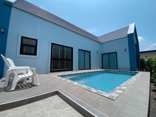 a swimming pool in front of a house at 286poolvilla in Surat Thani