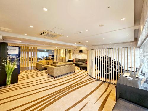 a large living room with a couch and a table at Hotel Foret Premier Nampo in Busan