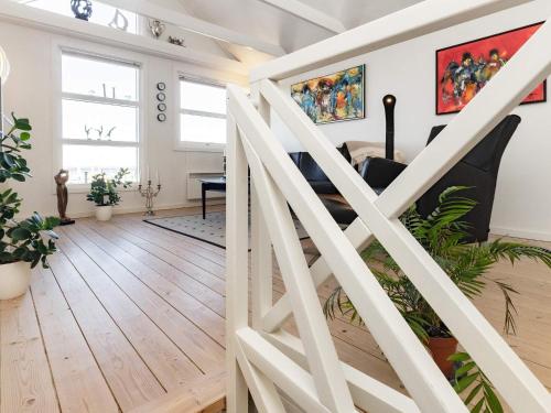 a staircase in a living room with wood floors at 5 person holiday home in Nibe-By Traum in Nibe