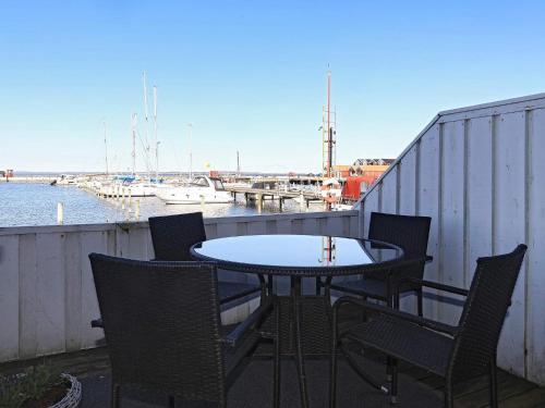 a table and chairs on a balcony with a marina at 5 person holiday home in Nibe-By Traum in Nibe