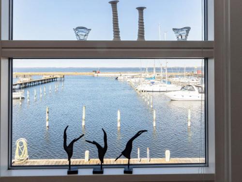 a window with a view of a marina at 5 person holiday home in Nibe-By Traum in Nibe