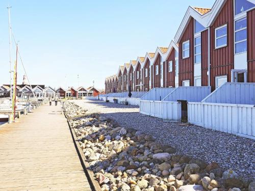 a row of houses on a beach with a boardwalk at 5 person holiday home in Nibe-By Traum in Nibe