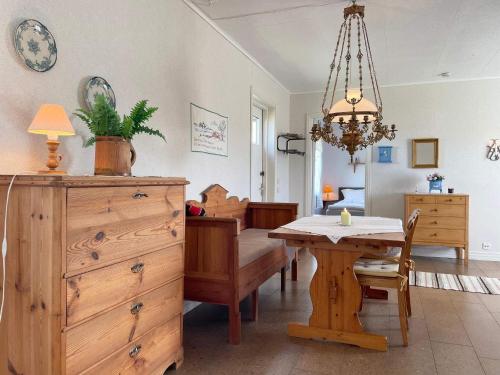 a dining room with a table and a chandelier at 5 person holiday home in Löttorp-By Traum in Löttorp