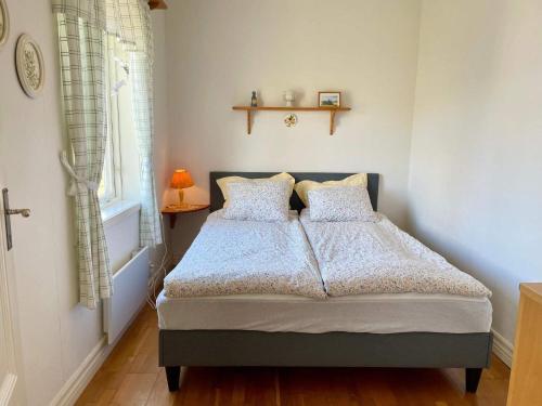a bedroom with a bed and a window at 5 person holiday home in Löttorp-By Traum in Löttorp
