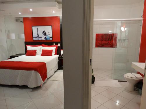 a bedroom with a bed and a shower and a bathroom at Pousada Solar Dom Kido in Torres