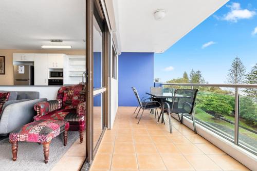 a living room with a couch and a table at Northwind Beachfront Apartments in Mooloolaba