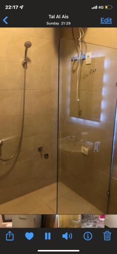 a shower with a glass door in a bathroom at Lovely penthouse 4- bedroom directly on the lagoon in El Alamein