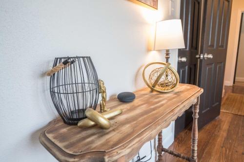 a table with a bird cage and a lamp on it at Casa Cima in Dallas