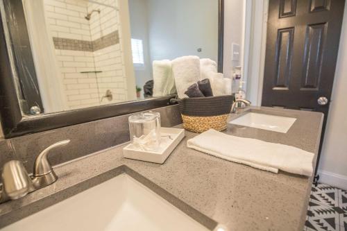 a bathroom counter with a sink and a mirror at Casa Cima in Dallas