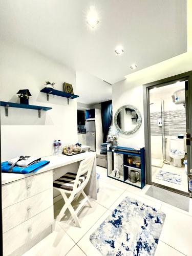 a white kitchen with a desk and a sink at Luxury Studio House 589-2 in 6th Of October