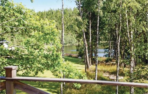 a view from the deck of a cabin in a forest at 3 Bedroom Stunning Home In Färgelanda in Muberg