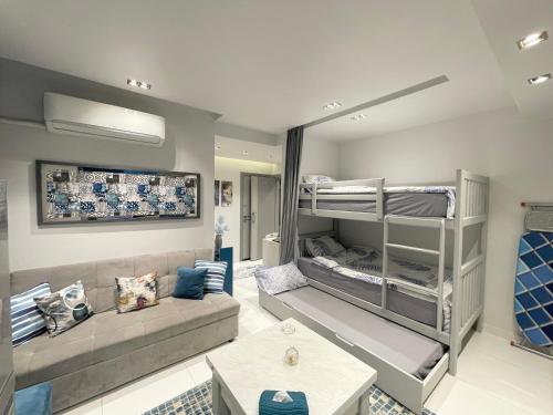 a living room with a couch and bunk beds at Luxury Studio House 589-2 in 6th Of October