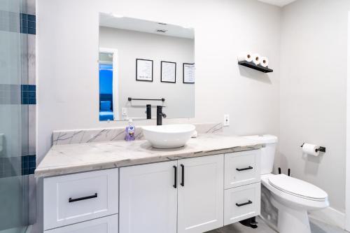 a white bathroom with a sink and a toilet at Hollywood Paradise Luxury 4BR 3BA Home and Outdoor Fun with Heated Pool in Hollywood