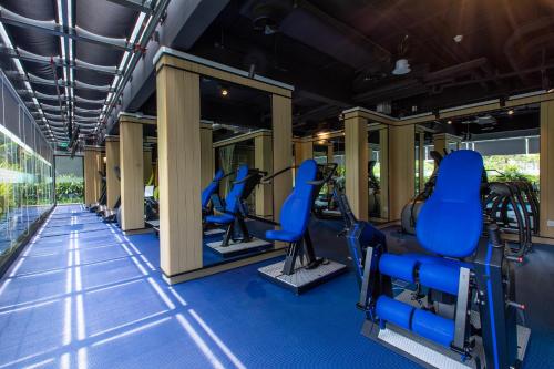 a gym with blue chairs in a building at Hotel Komune Living & Wellness Kuala Lumpur in Kuala Lumpur