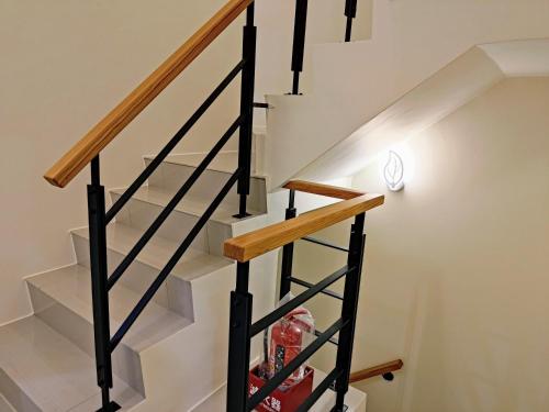 a staircase with black and white railings at Wish Homestay in Dayin
