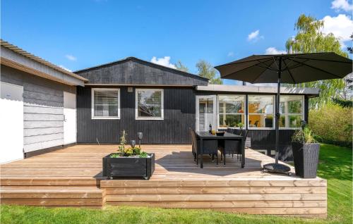 a patio with a table and an umbrella at Holiday Home Teglager K-674 in Hejls