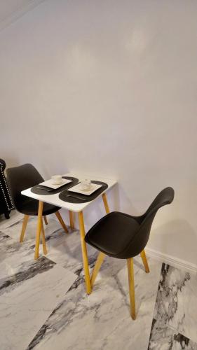 a black chair and a table in a room at MAKATI Isabela Luxury in Manila