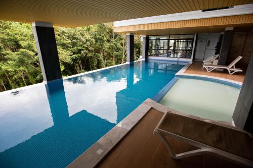 a swimming pool with a view of a house at VIP Great Hill in Nai Yang Beach