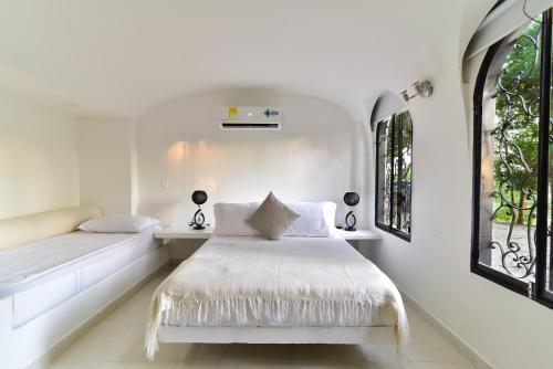 Una cama o camas en una habitación de Aldea Bella Boutique