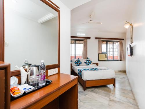 a hotel room with a bed and a mirror at Hotel Galaxy Opp Surat Railway Station in Surat