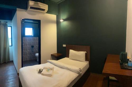 a bedroom with a bed and a desk and a room at Room V at Kluang Parade Near Bus Stop Kluang in Kluang