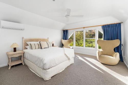 a white bedroom with a large bed and a window at Glen Regan Berrima in Berrima