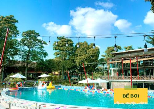 a large swimming pool with a water park at Wonder Farm Ba Vi - Heritage Retreat in Hà Lộc