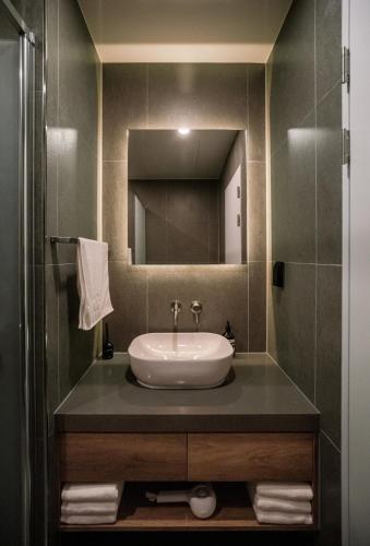 a bathroom with a sink and a mirror at Jeju Eedo in Jeju